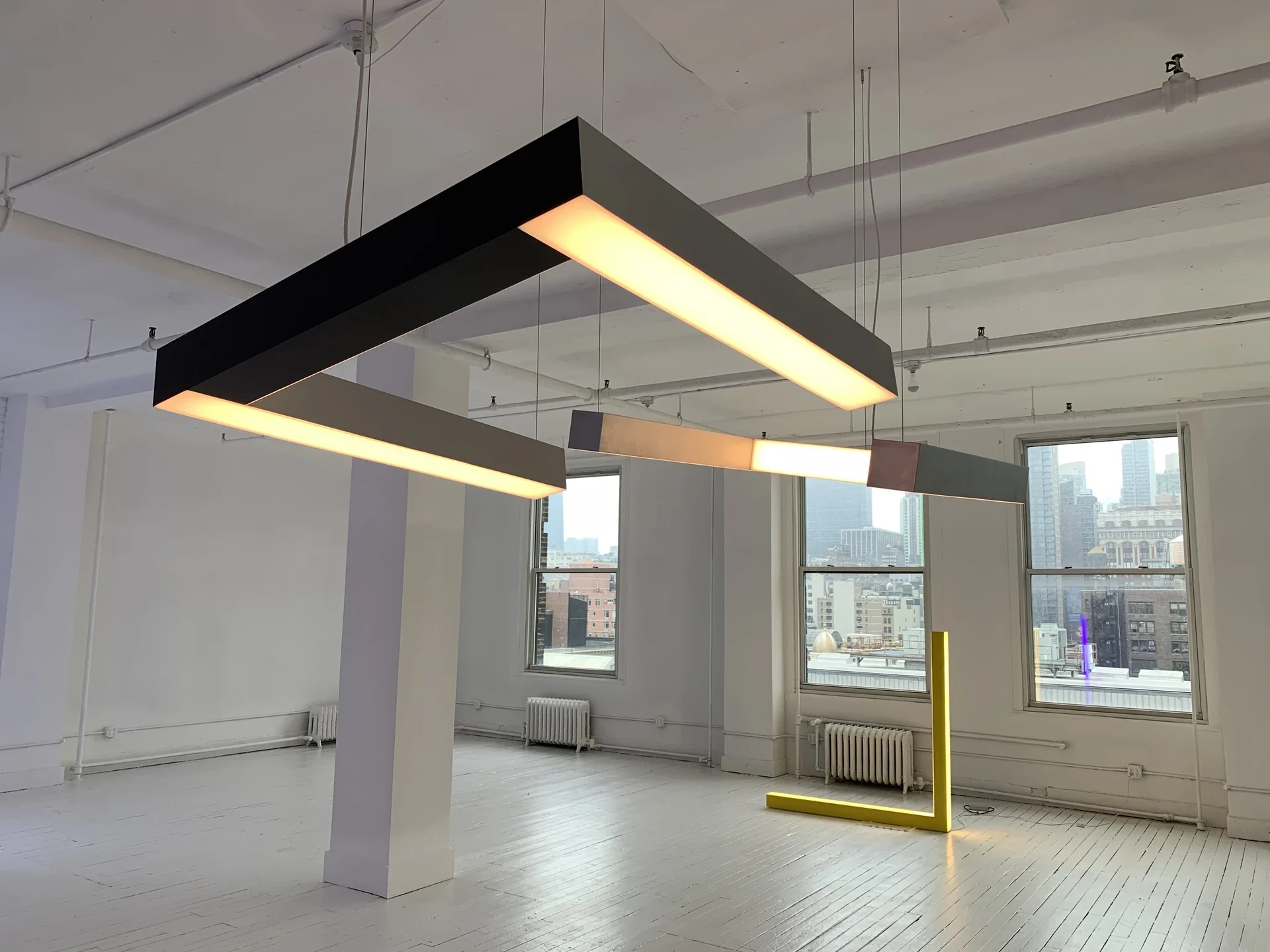 The suspended pendant illuminated in the gallery.