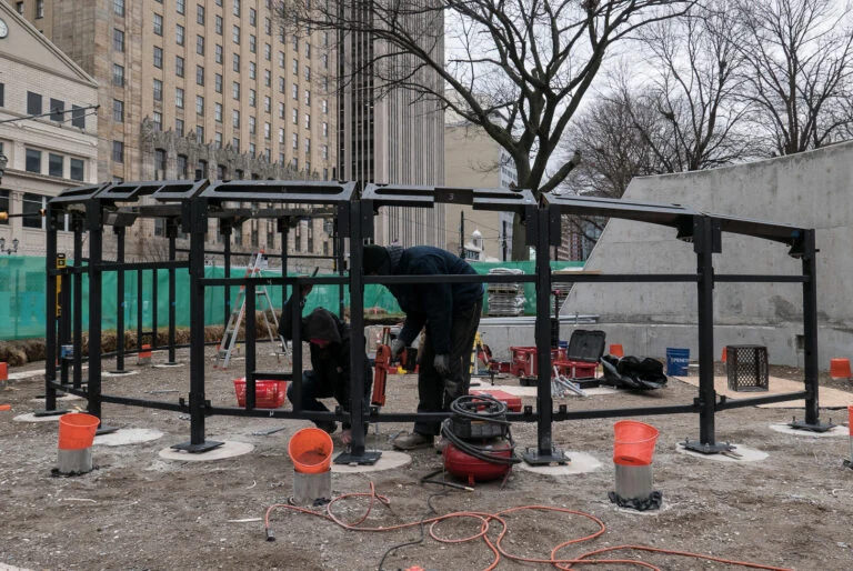 The curved steel learning-wall frame during installation in Newark